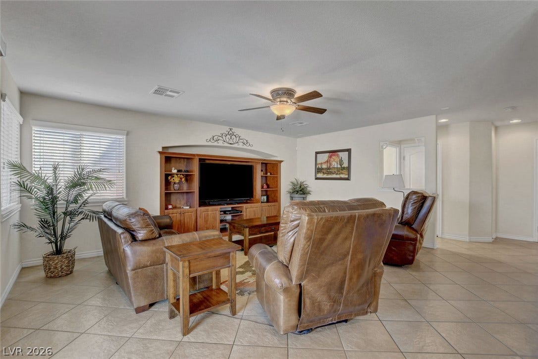 5508 Meridian Rain Street, North Las Vegas, NV 89031 Tiled flooring and recessed lighting accent this spacious, open-concept living area.