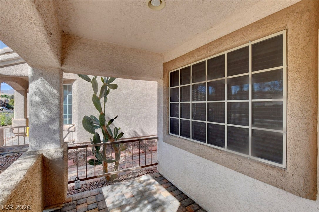5508 Meridian Rain Street, North Las Vegas, NV 89031 A welcoming covered porch features textured stucco walls and classic brick paver flooring.