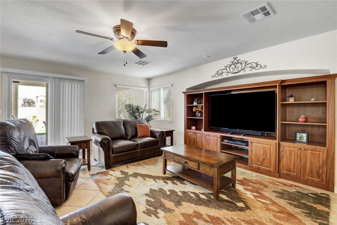 5508 Meridian Rain Street, North Las Vegas, NV 89031 An arched alcove frames a large built-in entertainment center over tile flooring.