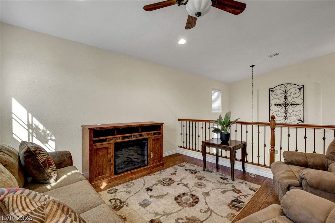 5508 Meridian Rain Street, North Las Vegas, NV 89031 Gleaming hardwood floors and a modern vaulted layout define this inviting upstairs bonus room.