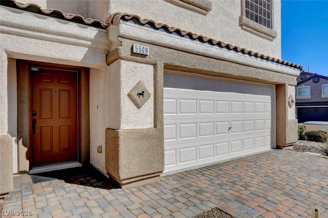 5508 Meridian Rain Street, North Las Vegas, NV 89031 Spanish tile accents and a paver driveway frame the welcoming stucco entry.