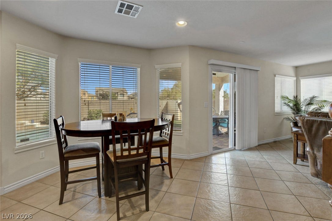 5508 Meridian Rain Street, North Las Vegas, NV 89031 Sunlight streams across the tiled floor through large windows and sliding glass doors.