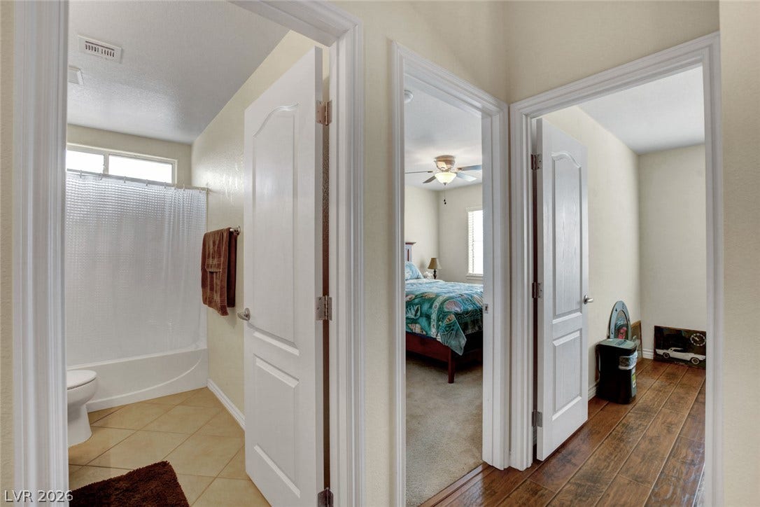 5508 Meridian Rain Street, North Las Vegas, NV 89031 An inviting hallway connects the bathroom, bedroom, and secondary living spaces seamlessly.