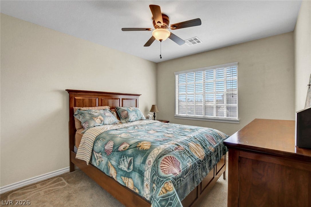 5508 Meridian Rain Street, North Las Vegas, NV 89031 Carpeted flooring and a wide window bring warmth and light to this cozy bedroom.