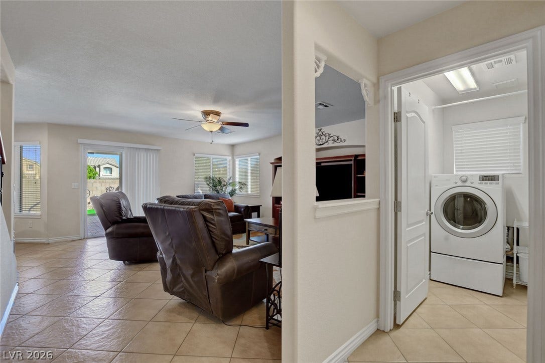 5508 Meridian Rain Street, North Las Vegas, NV 89031 Tile flooring runs throughout the open main level containing a living room and laundry alcove.