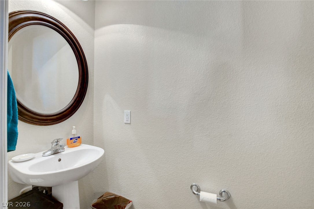 5508 Meridian Rain Street, North Las Vegas, NV 89031 An elegant pedestal sink anchors this classic powder room setup.