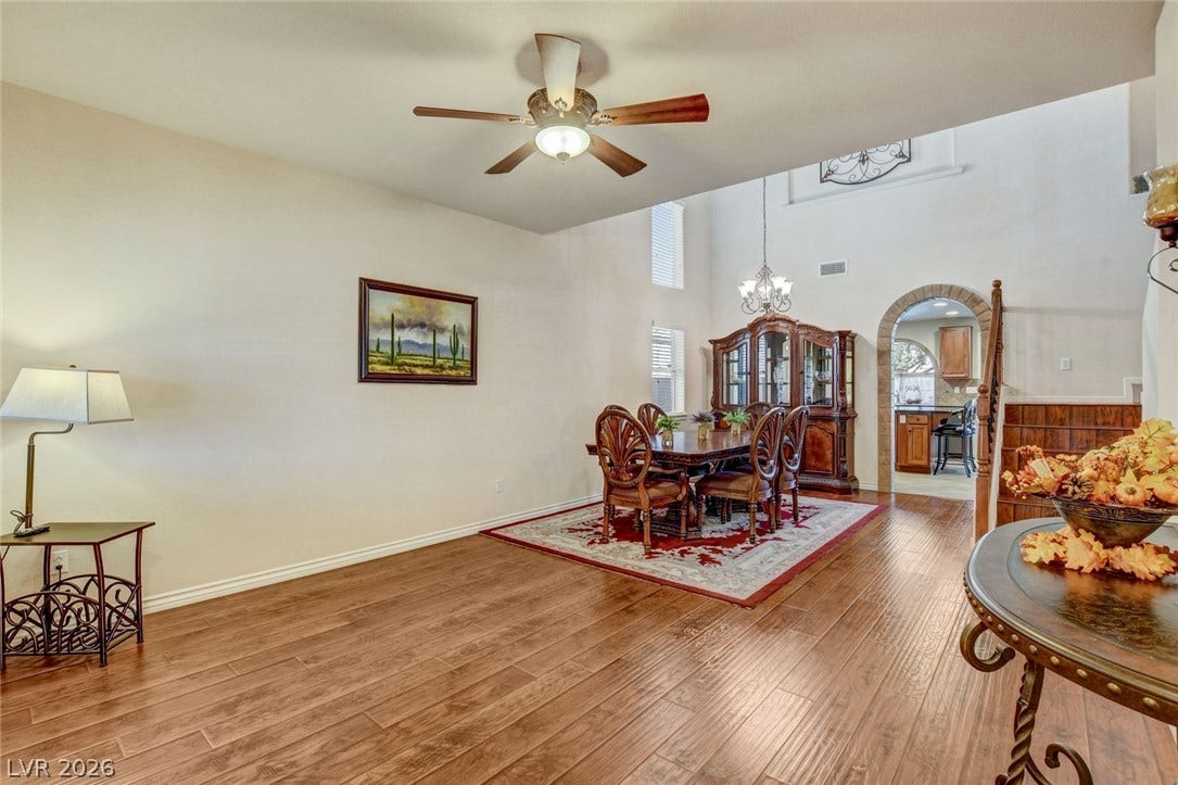 5508 Meridian Rain Street, North Las Vegas, NV 89031 Gleaming hardwood floors and a brick-arched doorway elevate this open dining area.