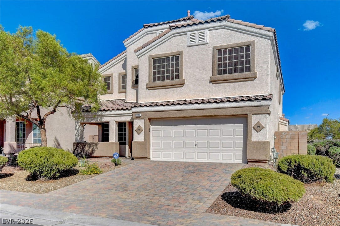 5508 Meridian Rain Street, North Las Vegas, NV 89031 A paved driveway leads to the integrated garage of this classic stucco exterior.