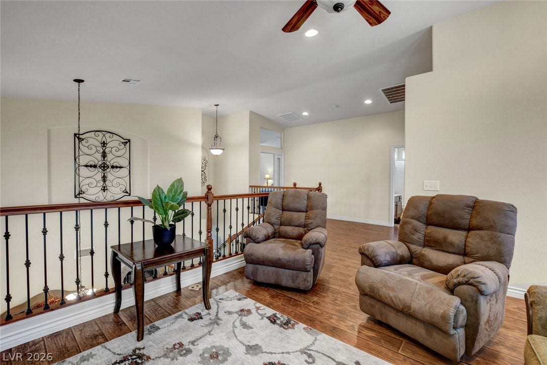 5508 Meridian Rain Street, North Las Vegas, NV 89031 Rich wood flooring and an open banister define this versatile upper-level landing space.
