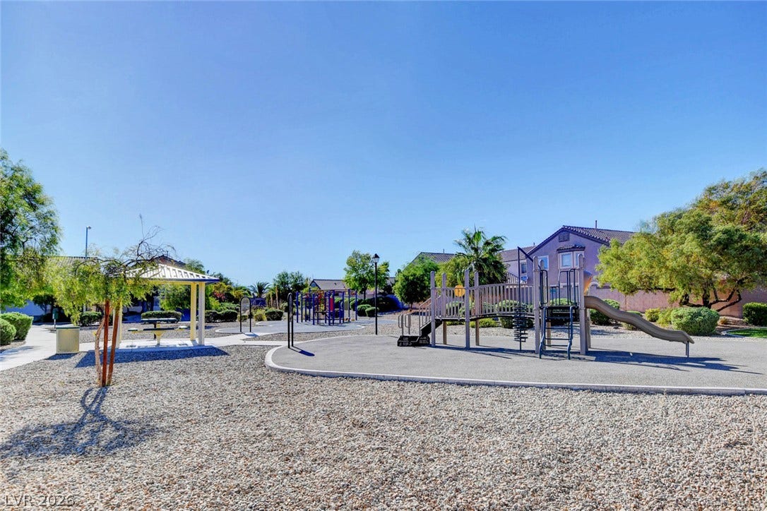 5508 Meridian Rain Street, North Las Vegas, NV 89031 A well-maintained community park provides recreational equipment under clear blue skies.