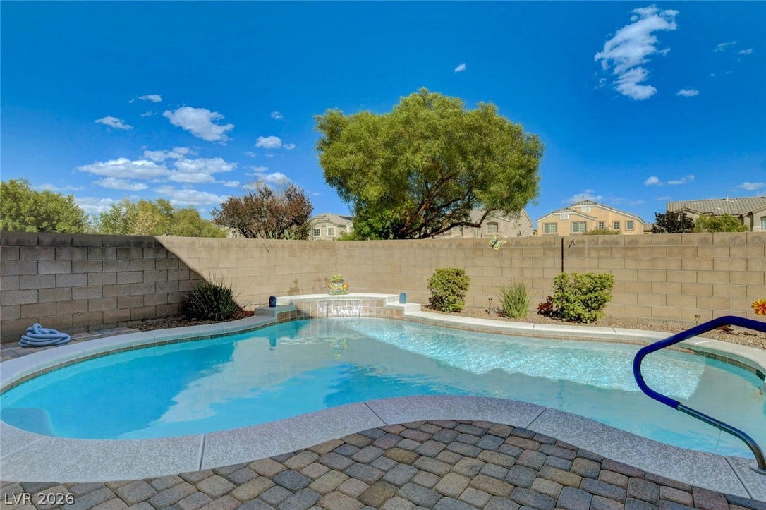 5508 Meridian Rain Street, North Las Vegas, NV 89031 An inviting backyard pool is bordered by paver stone decking and a privacy block wall.