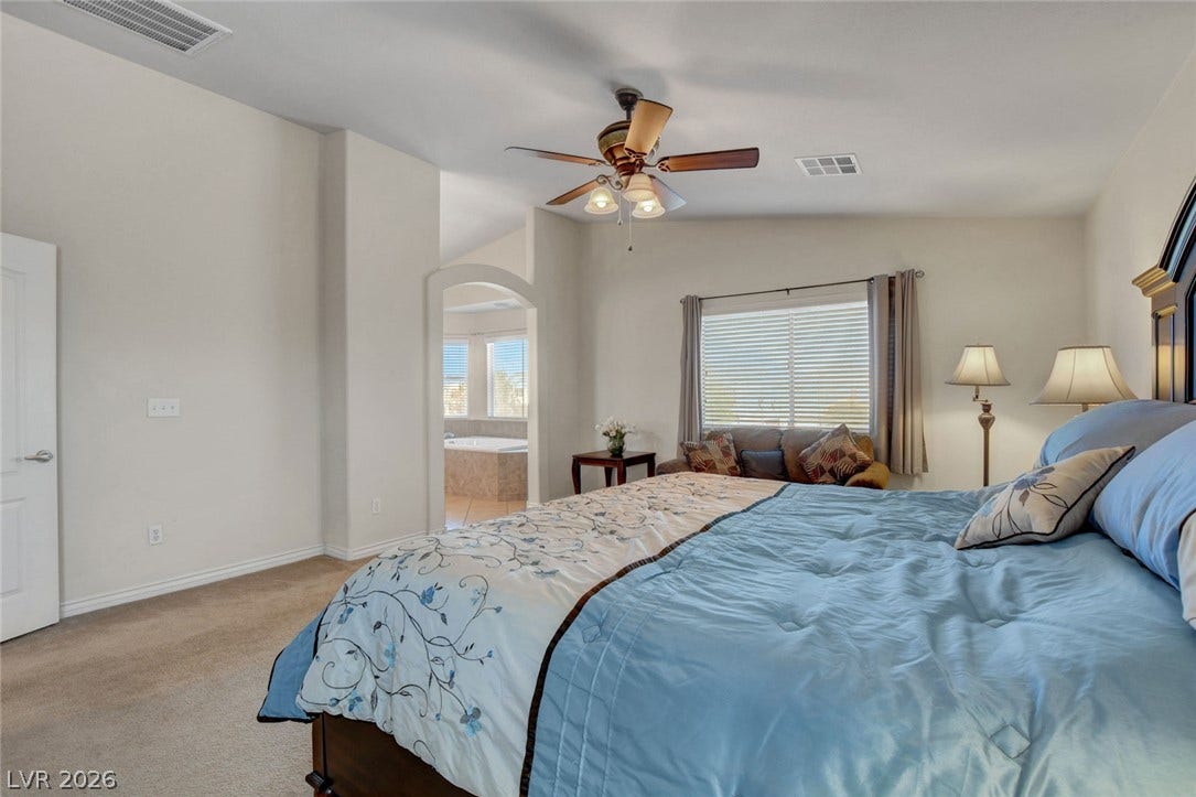 5508 Meridian Rain Street, North Las Vegas, NV 89031 High ceilings and soft carpet floor define this comfortable primary bedroom suite.