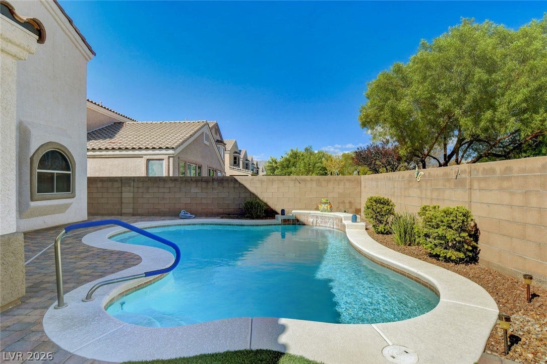 5508 Meridian Rain Street, North Las Vegas, NV 89031 A sparkling in-ground pool is framed by pavers and a block wall privacy fence.