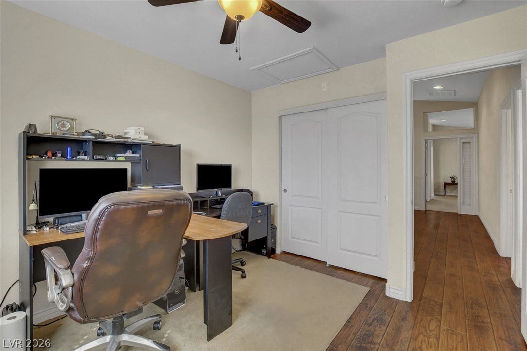 5508 Meridian Rain Street, North Las Vegas, NV 89031 Rich hardwood floors flow seamlessly from the versatile home workspace into the hallway.