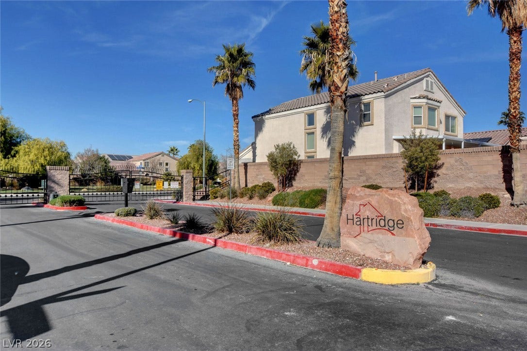 5508 Meridian Rain Street, North Las Vegas, NV 89031 A gated entrance with stone monument signage welcomes residents to this desert community.