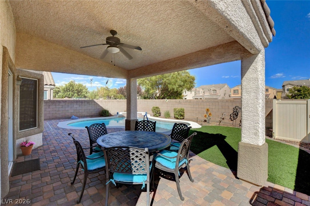 5508 Meridian Rain Street, North Las Vegas, NV 89031 A shaded brick paver patio overlooks the private backyard pool under clear blue skies.