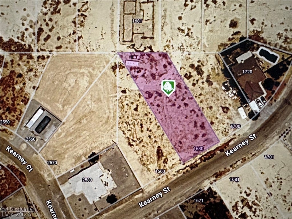 Aerial view showcasing a potential lot with convenient street access and neighboring properties.