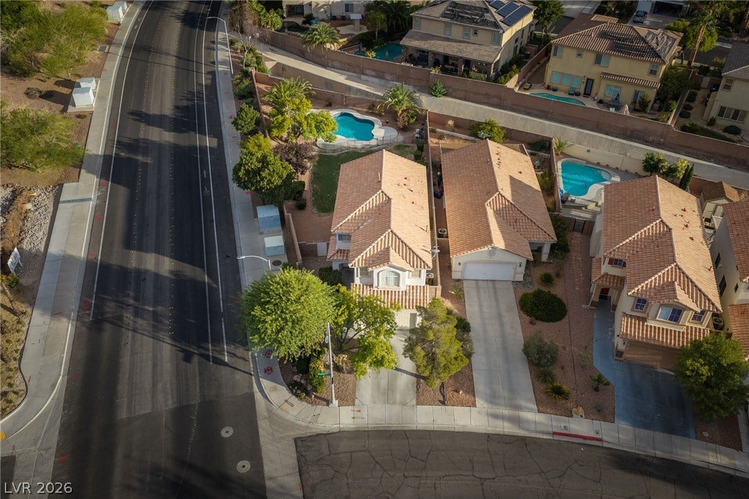 2381 Predera Avenue, Henderson, NV 89052 An aerial perspective captures tile-roofed residences nestled alongside a quiet street.