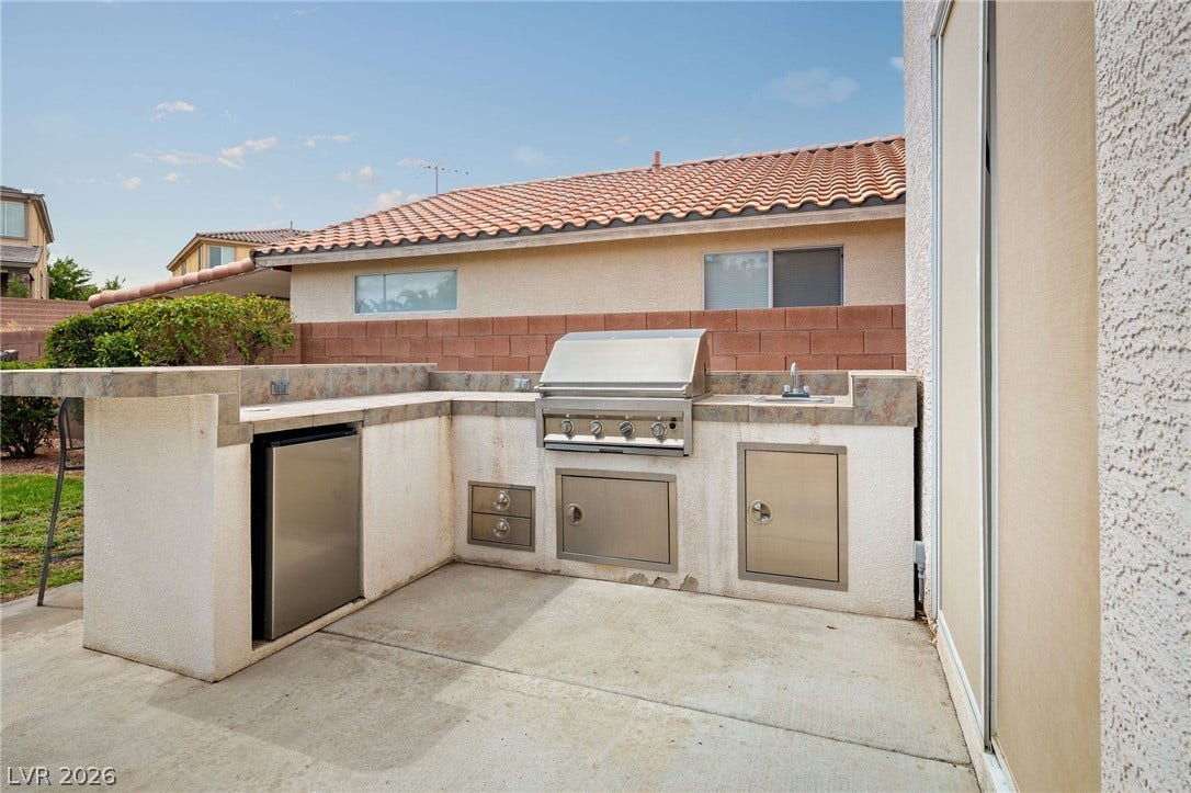 2381 Predera Avenue, Henderson, NV 89052 An outdoor kitchen features a built-in barbecue grill alongside a convenient prep station.