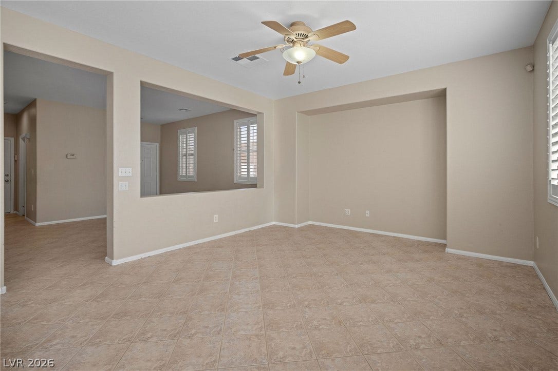 2381 Predera Avenue, Henderson, NV 89052 Tiled flooring and a large wall cutout define this versatile, open living area.