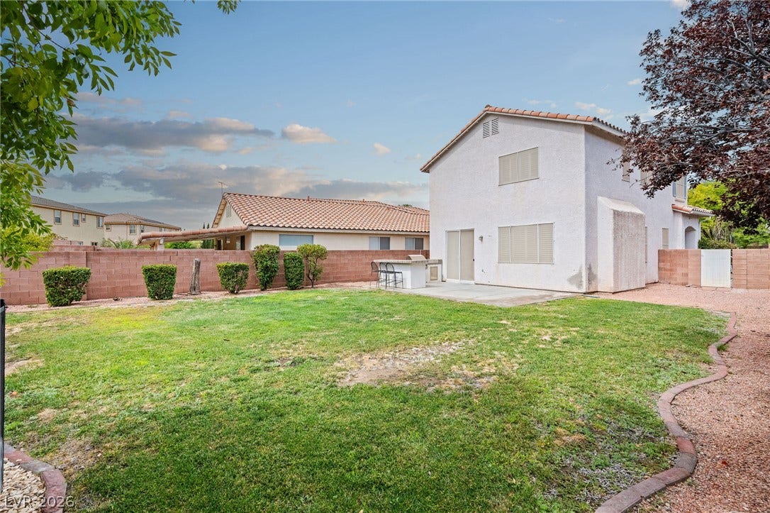 2381 Predera Avenue, Henderson, NV 89052 A spacious grassy lawn highlights this fenced backyard featuring a concrete patio.