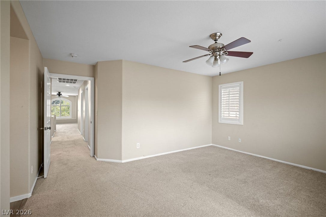 2381 Predera Avenue, Henderson, NV 89052 Plush carpet flooring and a shuttered window anchor this versatile upstairs bedroom.