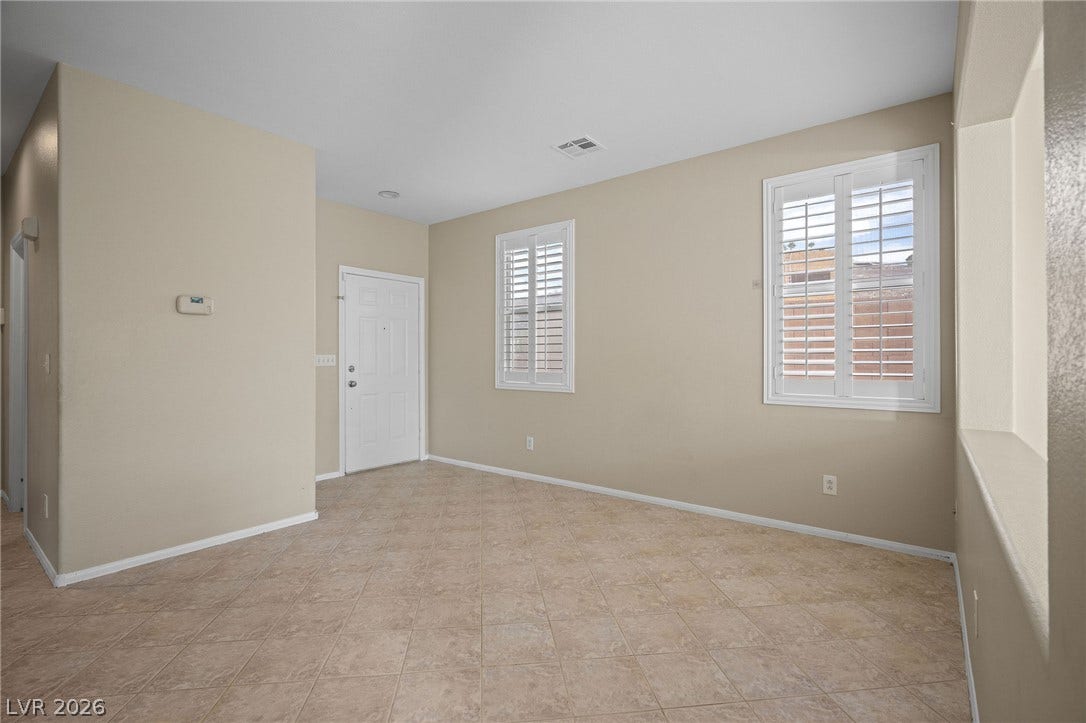 2381 Predera Avenue, Henderson, NV 89052 Tiled flooring and white plantation shutters anchor this versatile entry space.