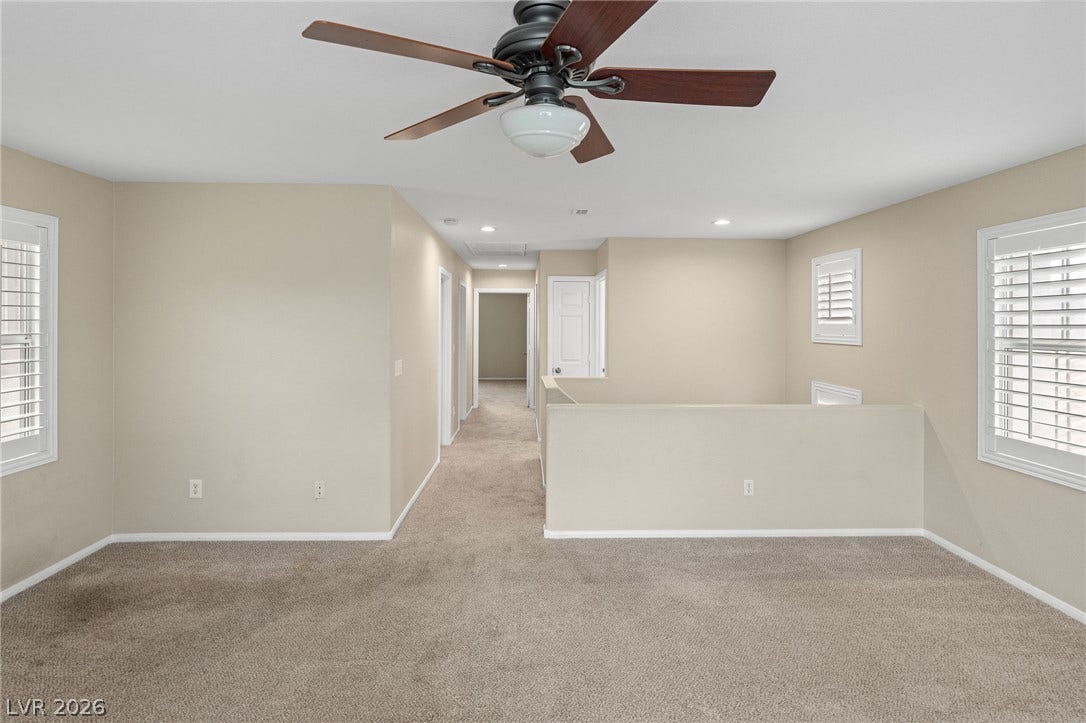 2381 Predera Avenue, Henderson, NV 89052 An open upper-level loft area boasts plush wall-to-wall carpeting and clean architectural lines.