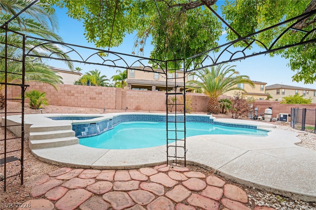 2381 Predera Avenue, Henderson, NV 89052 A sparkling swimming pool highlights this backyard oasis enclosed by high privacy walls.
