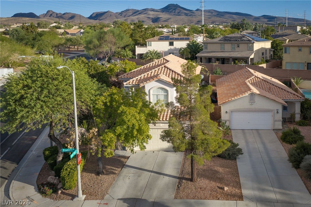 2381 Predera Avenue, Henderson, NV 89052 Nestled in a quiet neighborhood, this home features classic tile roofing and mountain backdrops.