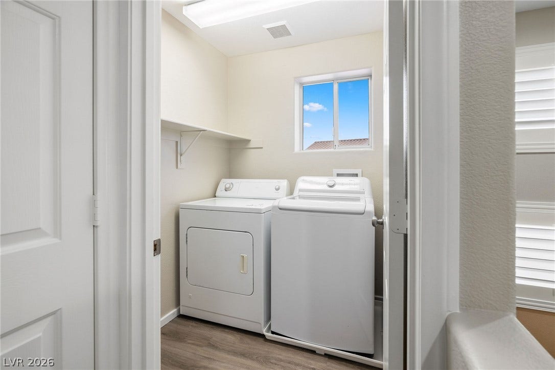 2381 Predera Avenue, Henderson, NV 89052 A dedicated utility space features wood-style flooring and a bright window overlooking the outdoors.