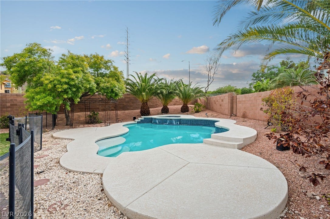 2381 Predera Avenue, Henderson, NV 89052 A sparkling in-ground pool serves as the centerpiece of this enclosed backyard oasis.