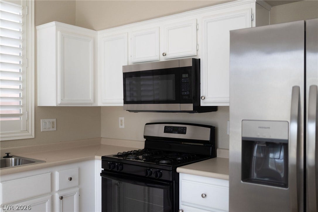 2381 Predera Avenue, Henderson, NV 89052 Crisp white cabinetry and stainless steel appliances complete this well-organized cooking space.