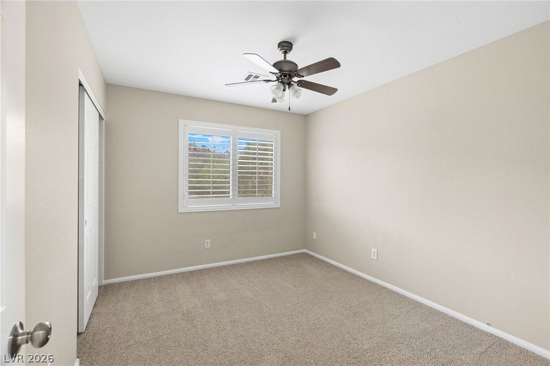 2381 Predera Avenue, Henderson, NV 89052 Plush carpeting and plantation shutters define this versatile secondary bedroom space.
