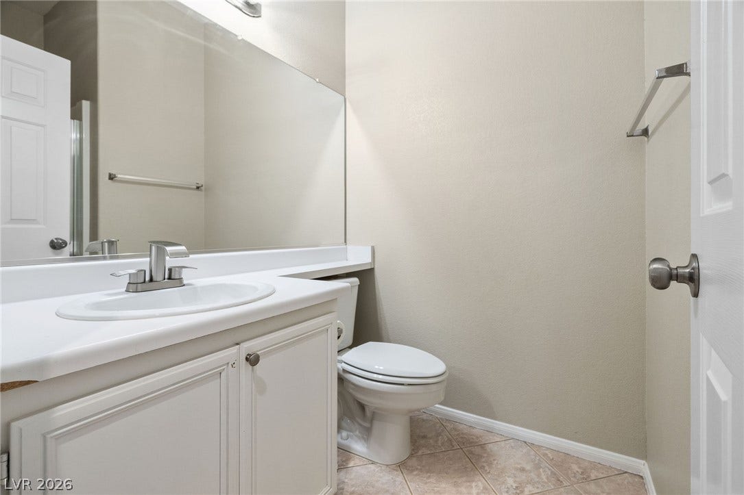 2381 Predera Avenue, Henderson, NV 89052 Clean lines and classic tile flooring define this functional powder room space.
