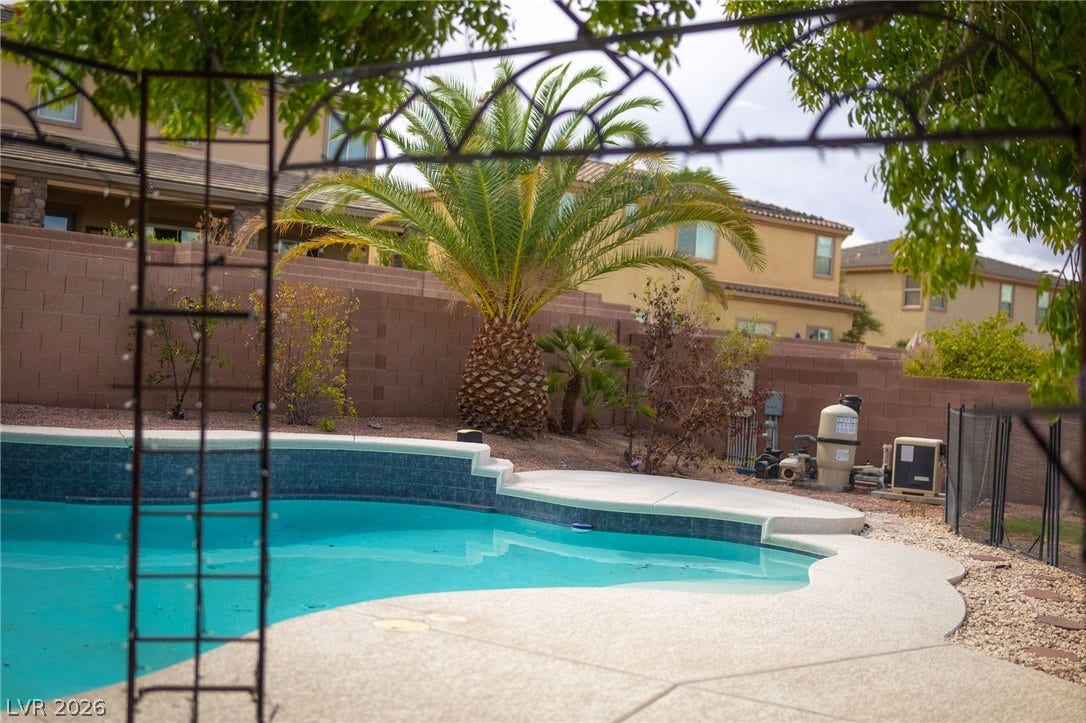 2381 Predera Avenue, Henderson, NV 89052 Mature palms and a curved pool anchor this private backyard oasis.