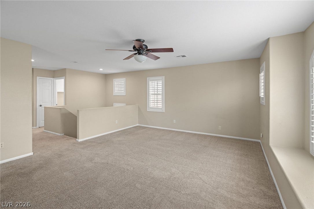 2381 Predera Avenue, Henderson, NV 89052 A spacious carpeted loft area provides versatile living space on the upper level.