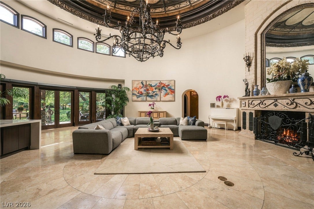1513 Foothills Village Drive, Henderson, NV 89012 A dramatic stone fireplace and soaring domed ceiling anchor this grand circular living space.