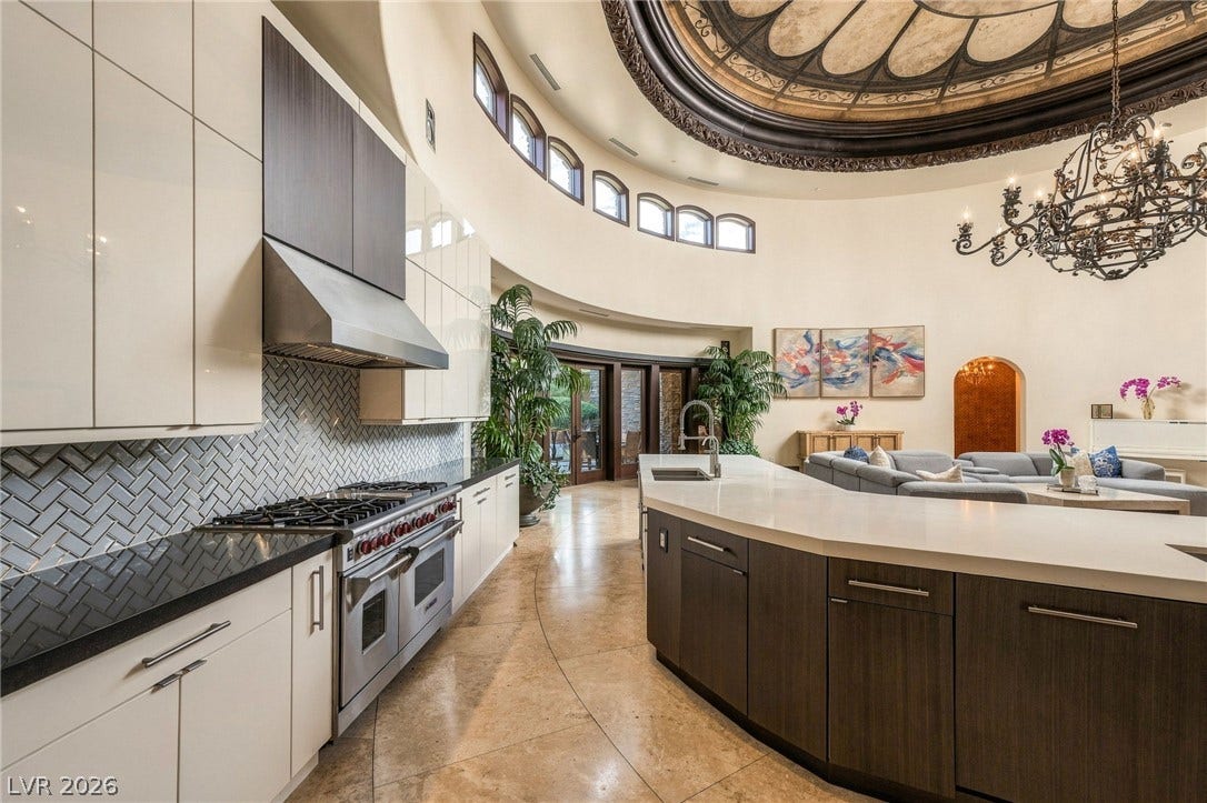 1513 Foothills Village Drive, Henderson, NV 89012 A curved kitchen layout highlights a dramatic domed ceiling and custom stone flooring.