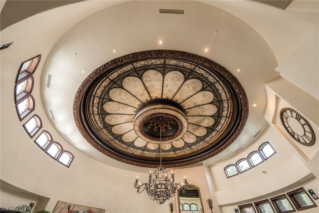 1513 Foothills Village Drive, Henderson, NV 89012 An ornate rotunda ceiling anchors the grand entryway with a dramatic wrought iron chandelier.