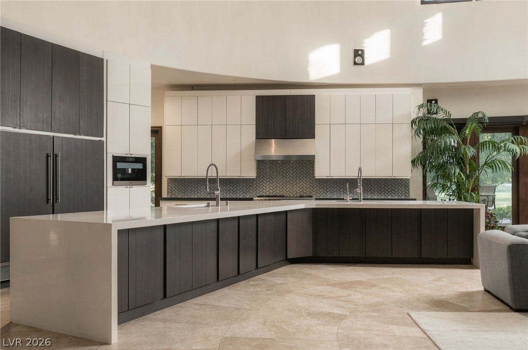 1513 Foothills Village Drive, Henderson, NV 89012 Sleek contemporary design defines this expansive kitchen featuring premium stone countertops and rich cabinetry.