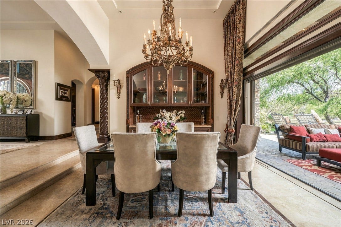 1513 Foothills Village Drive, Henderson, NV 89012 A grand dining space seamlessly transitions to the outdoors through massive sliding glass doors.