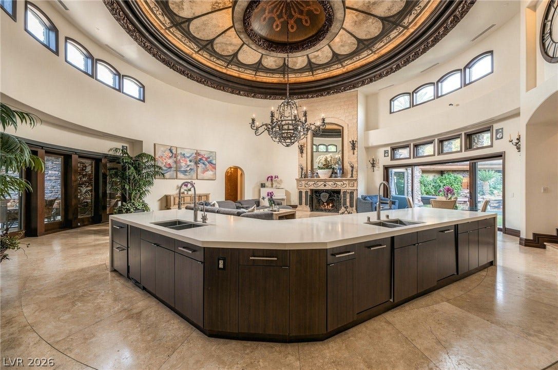 1513 Foothills Village Drive, Henderson, NV 89012 A striking circular ceiling dome and vast curved island define this grand open space.
