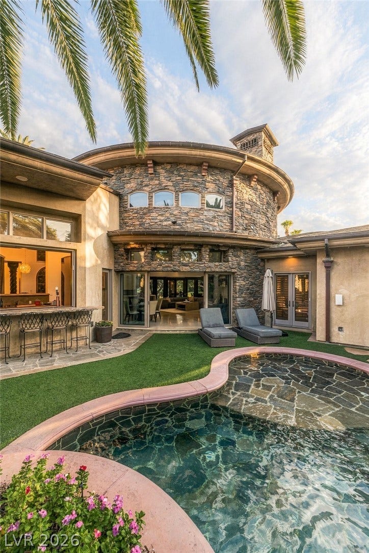 1513 Foothills Village Drive, Henderson, NV 89012 Custom stone accents and a curved architectural design frame the resort-style pool deck.