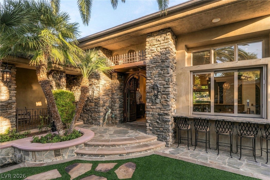 1513 Foothills Village Drive, Henderson, NV 89012 Textured stone pillars frame the entrance and a built-in outdoor bar area.