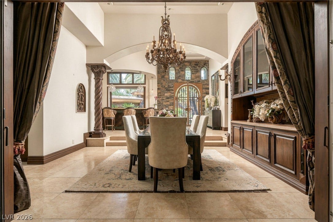 1513 Foothills Village Drive, Henderson, NV 89012 An elegant dining room features polished tile flooring, built-in cabinetry, and a dramatic arched opening.