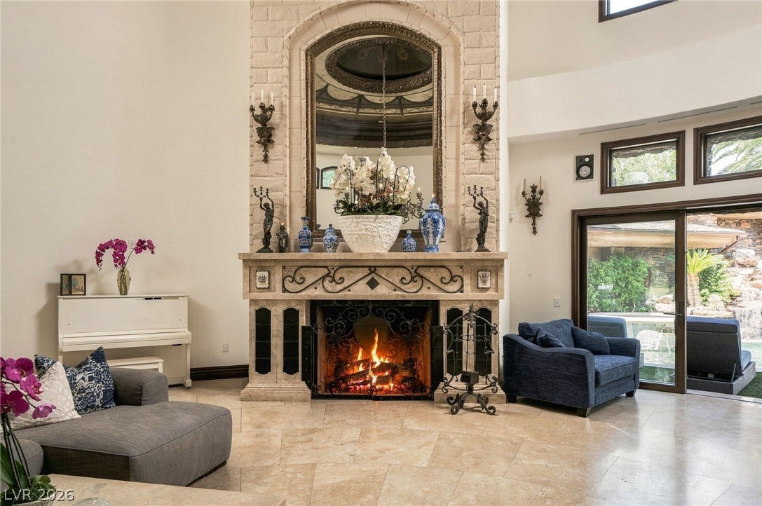 1513 Foothills Village Drive, Henderson, NV 89012 An ornate stone fireplace commands attention in this grand living room with soaring ceilings.