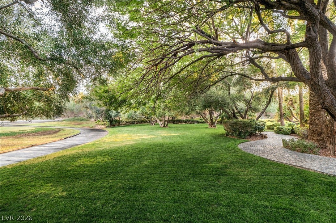 1513 Foothills Village Drive, Henderson, NV 89012 Mature trees shade a manicured lawn alongside paved walking paths.