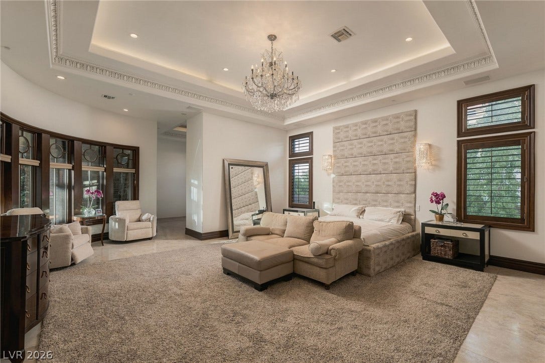 1513 Foothills Village Drive, Henderson, NV 89012 An elegant tray ceiling with crown molding elevates this grand, light-filled primary suite.