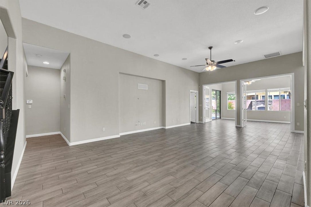 High ceilings and extensive tile flooring create an airy atmosphere throughout this versatile space.